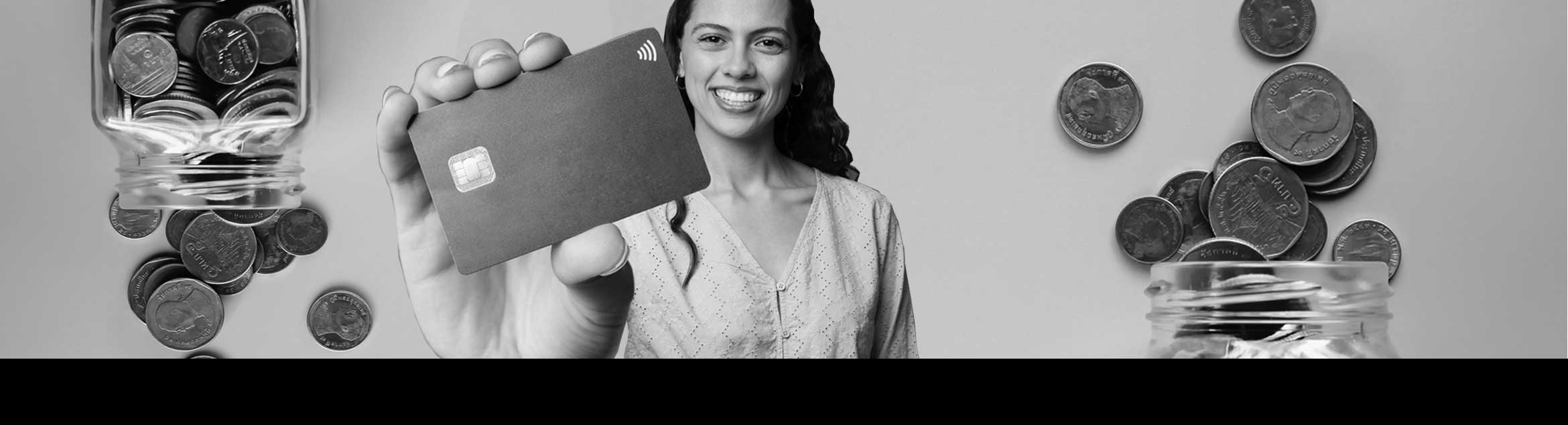 Photo of a smiling woman with a debit card, jars of coins in the background.